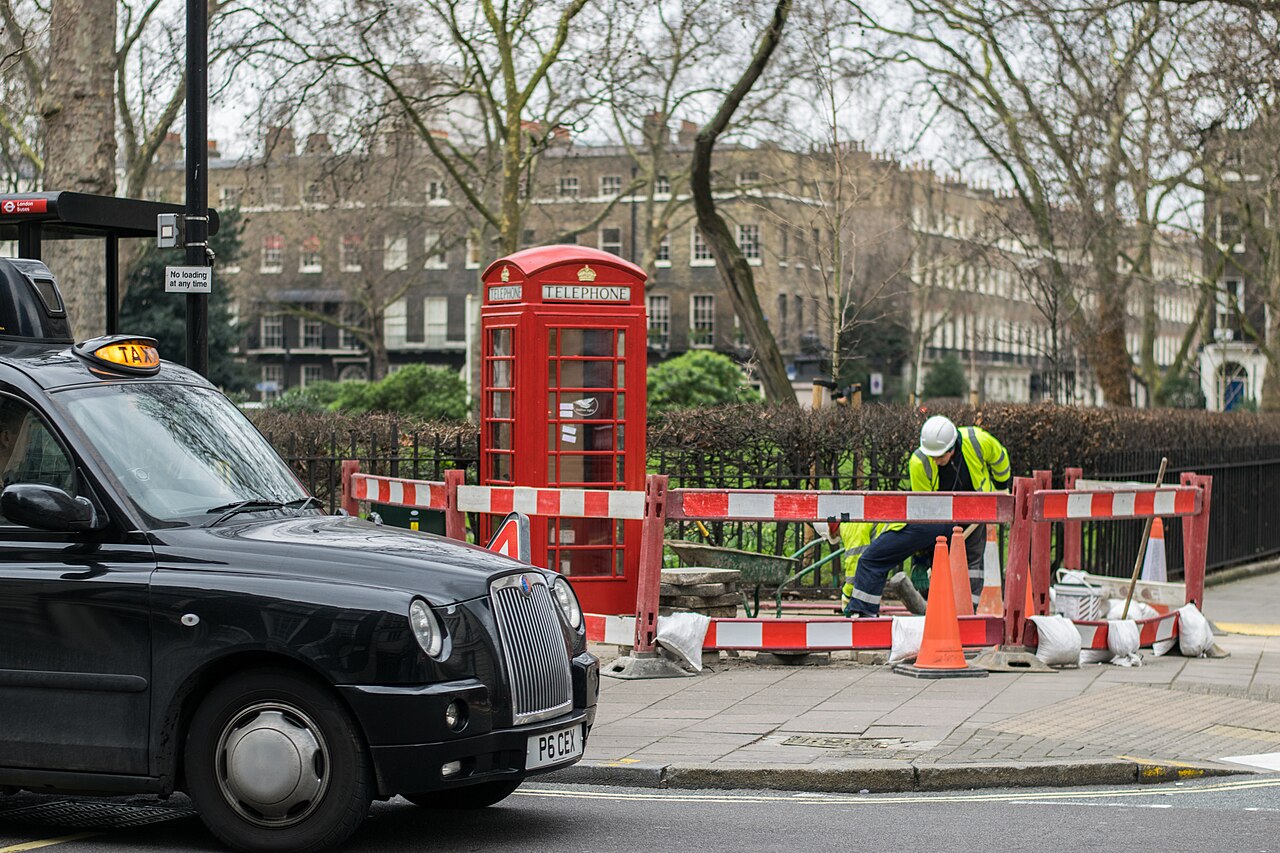 Workers and construction equipment on a London street